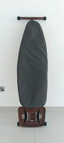 Used standing ironing board with built-in iron rest