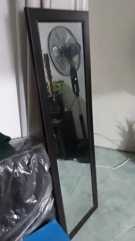 tall mirror wall resting or hanging