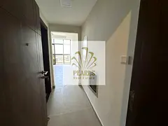 A luxurious annual rental apartment in Al Jurf 2, near Ajman Court, featuring 2 master bedrooms, a s