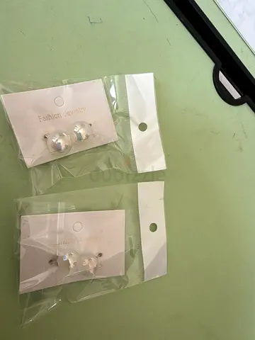 New silver floral stud earrings — pair, unused in packaging