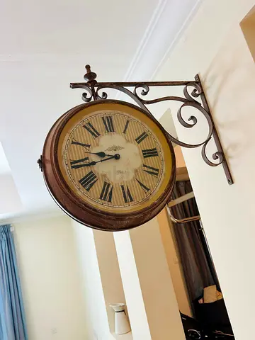 Vintage Double-Sided Wall Clock with Ornate Iron Bracket