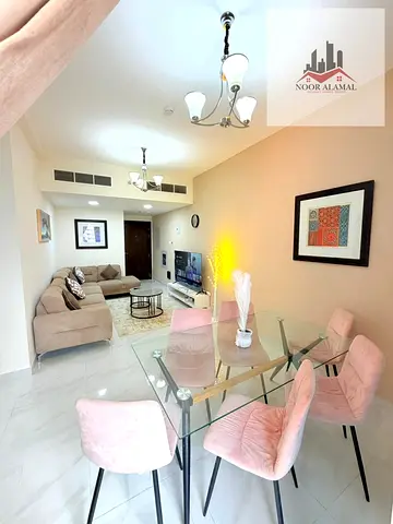 Sharjah, Al Taawun area, two-bedroom apartment with living room, kitchen, two bathrooms, shower, and balcony.