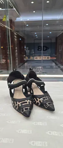 Black and beige patterned pointed-toe heels with ankle strap - size available