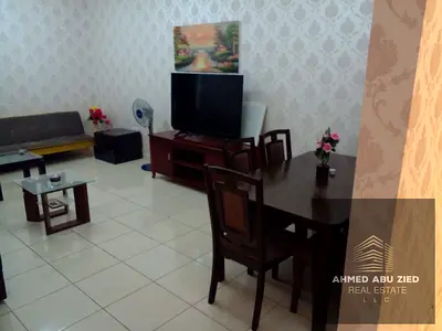 Luxury furnished one-bedroom apartment for annual rent in Orient Towers, Ajman | Balcony, open view, swimming pool, and gym
