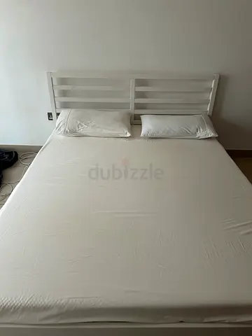 White wooden double bed frame with mattress - clean simple design