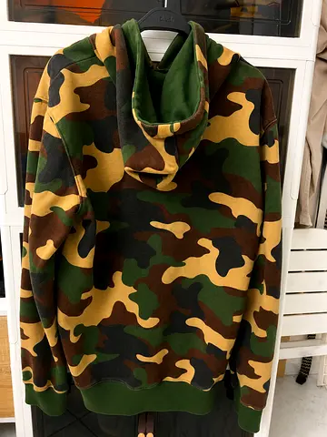Urban Waste (UW) New York City camouflage full-zip hoodie. Green/brown/tan woodland camo, adjustable