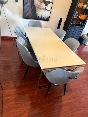 Modern white dining table with 6 grey upholstered chairs