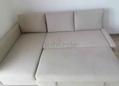 Light beige L-shaped sofa bed — converts to bed, good condition