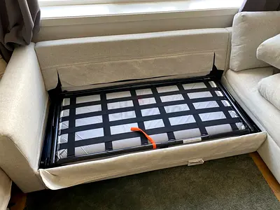 Light beige sofa with pull-out bed — single-seater / chaise section (good condition)
