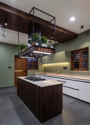 Modern kitchen island with overhead planter and built-in gas hob