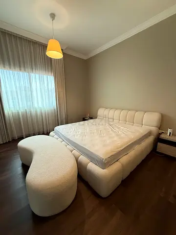 Cream king-size bed with mattress and matching ottoman