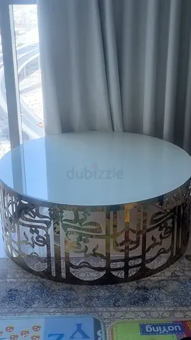 Round mirrored coffee table with decorative metal base