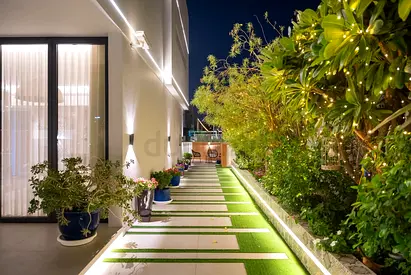 Outdoor garden walkway with planters and lighting