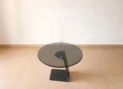 Round glass side table with modern metal base