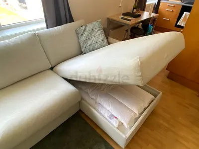 Light grey L-shaped storage sofa with under-seat compartment