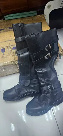 Black knee-high leather buckle boots, size not specified