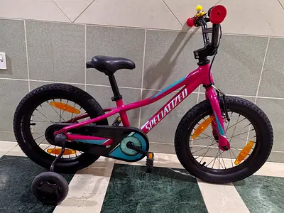 Used few times Specialized kids bike size 16 with original side wheels and extra bell Neat and clean