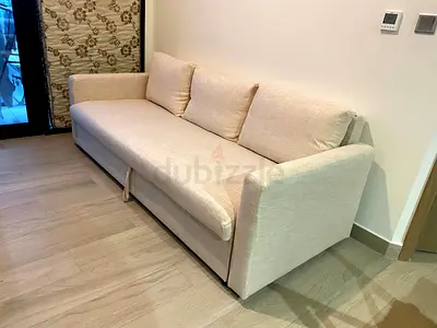 Beige linen sofa bed with hidden storage