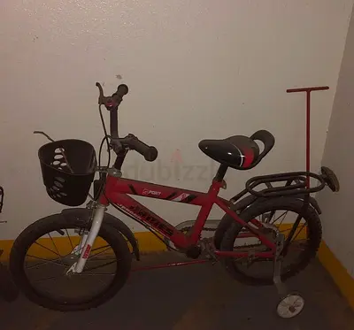 Kids red 16-inch bicycle with training wheels and basket
