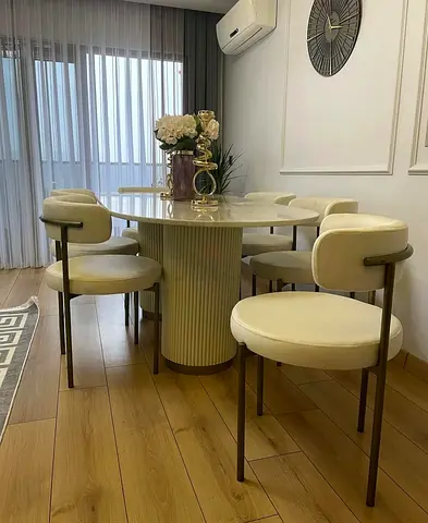 Round dining table with 6 cream upholstered chairs - modern set