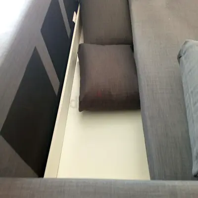 Grey L-shaped sofa with under-seat storage - good condition