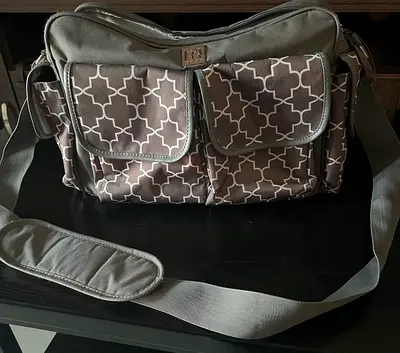 Grey patterned baby diaper bag with multiple pockets and shoulder strap