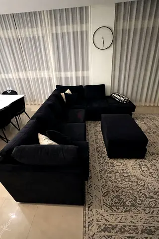 Black 6 seater L shape sofa with footstool