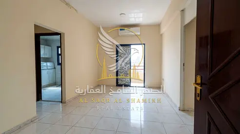 2BR apartment for annual rent in Al Shuwaihean staff contract balcony with open view spacious layout modern finishing and strategic location