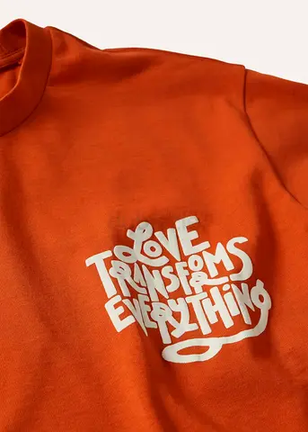 Orange crewneck sweatshirt with 'Love Transforms Everything' print - Size L
