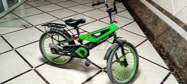 Green kids' 20-inch bicycle with stabilizer mounts, good condition