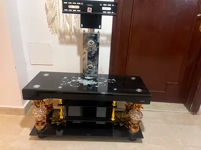 Black Glass TV Stand with Decorative Gold Accents
