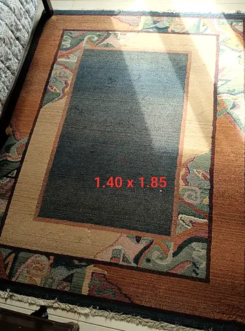 Used rectangular area rug 1.40 x 1.85 m - muted geometric border