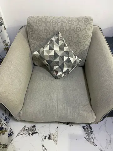 Single beige upholstered armchair with cushion - good condition