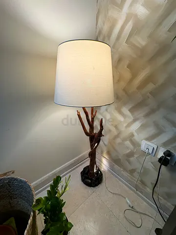 Lamp made out of natural tree trunk with LEDs running along the trunk