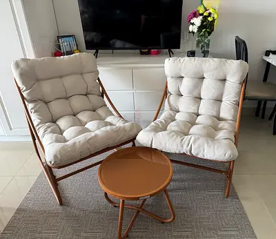 Pair of cozy tufted lounge chairs with small side table (Danube Home)