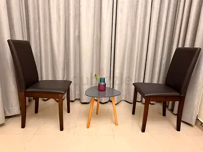 Pair of dark brown dining chairs in good condition with a coffee table