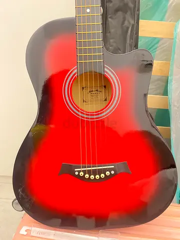 Red sunburst acoustic guitar with soft case - good used condition |AED 199
