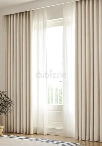 Full-length beige blackout curtains with sheer voile panels