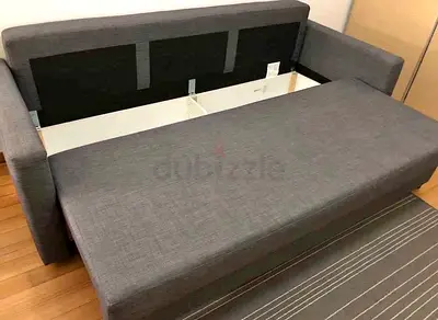 Grey fabric sofa bed with storage — good condition