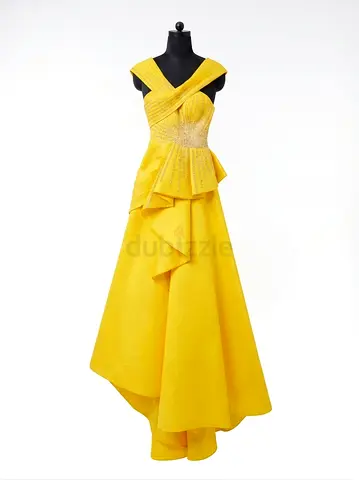 A formal yellow evening gown with a peplum design, crisscrossing front straps from the shoulders and