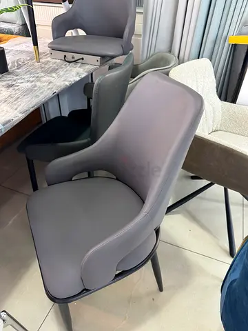 Modern grey upholstered dining chair with armrests
