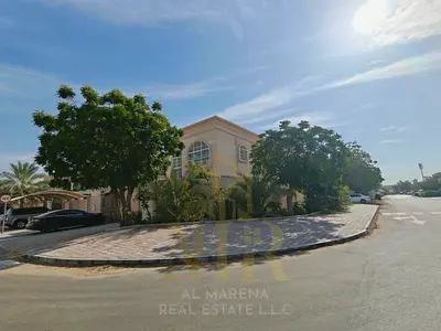 Corner villa for sale in Al Rawda 3 area, price includes electricity, water, and air conditioning. Freehold ownership for all nationalities.