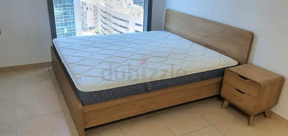Bed with mattress and side table