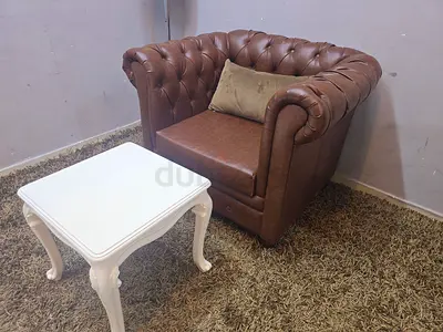 Brown Chesterfield-style Leather Armchair with Accent Pillow