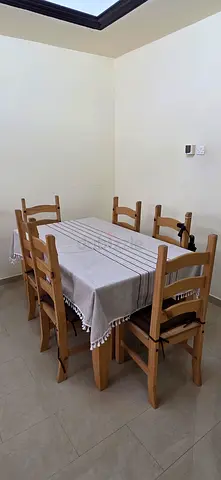 Wooden dining table for sale with 6 chairs negotiatable