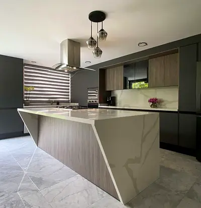 Modern kitchen island with marble finish and built-in cooktop