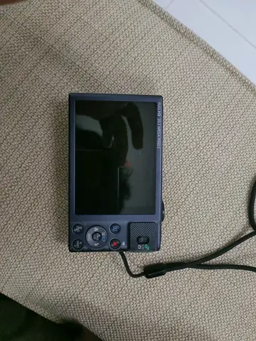 Compact digital camera (used) with wrist strap - powers on, screen intact