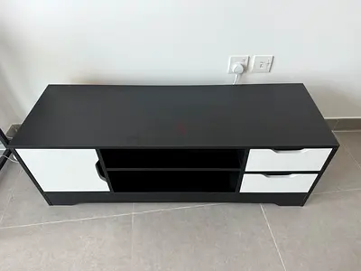 Simple black TV stand with storage drawers and shelves