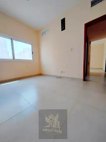 An apartment featuring master bedrooms is available for annual rent in the Al Musalla area of ​​Sharjah. It is situated in a prime location close to a