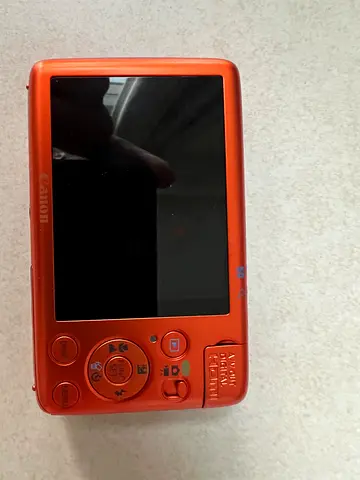 Canon compact digital point-and-shoot camera — orange, used